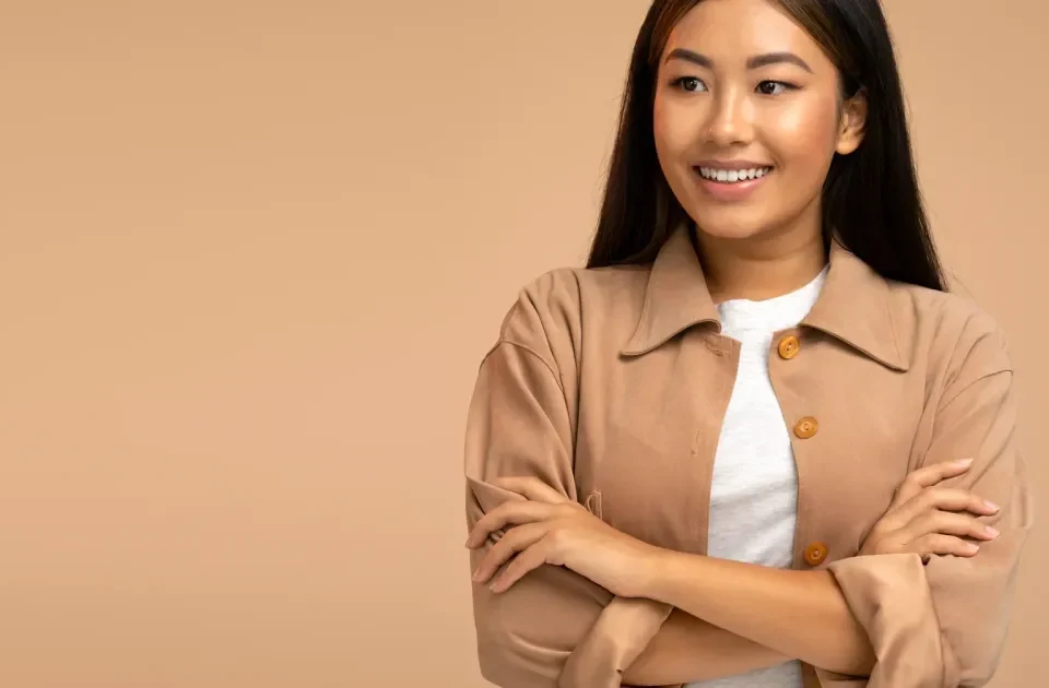 Woman smiling confidently with warm expression and natural lighting