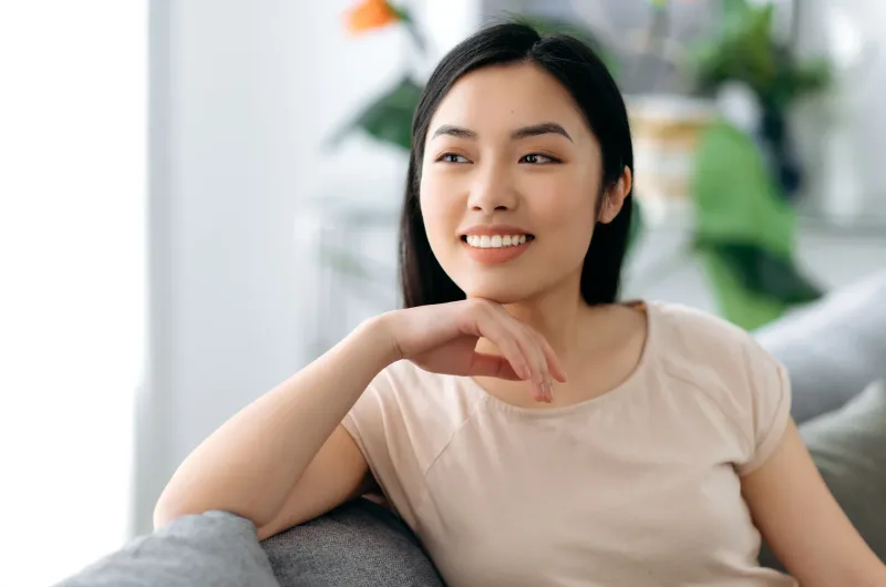 Woman relaxing indoors with friendly, approachable demeanor