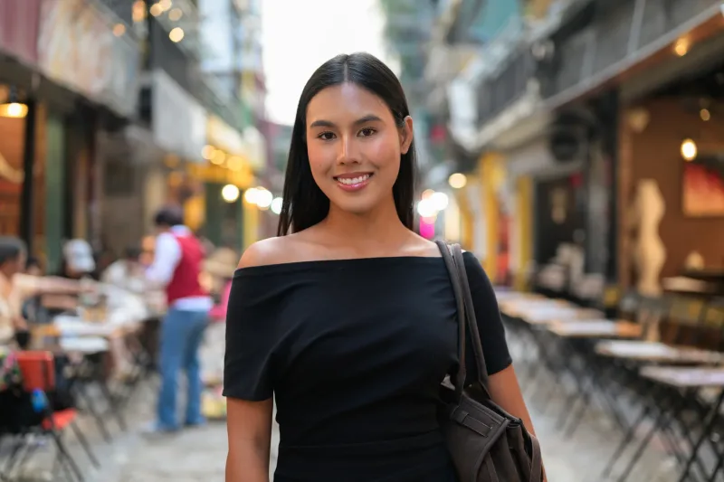 Woman smiling in casual urban setting, relaxed and approachable portrait