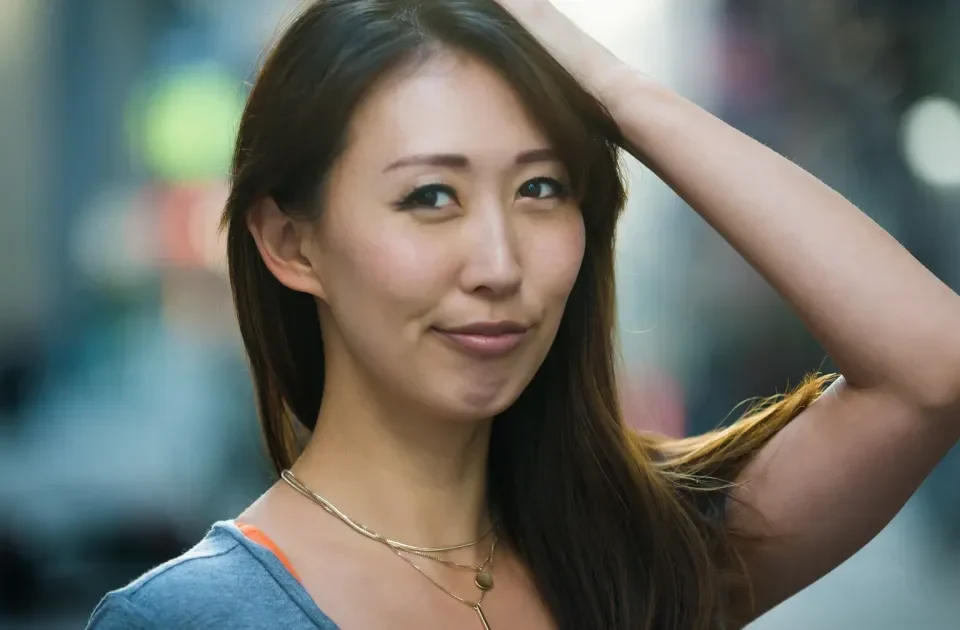 Woman smiling confidently with warm, approachable expression