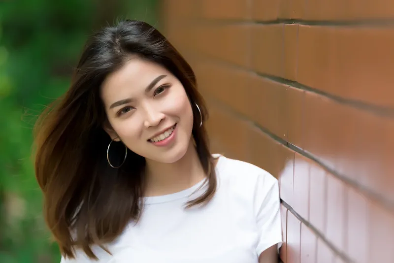 Young woman with confident smile outdoors, embodying the emotional openness at the heart of harana courtship
