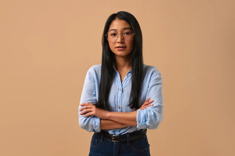 Woman in casual business attire with confident, professional demeanor