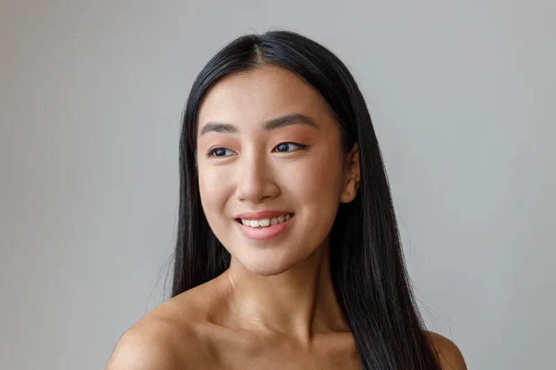 Cheerful woman in warm studio lighting with friendly expression