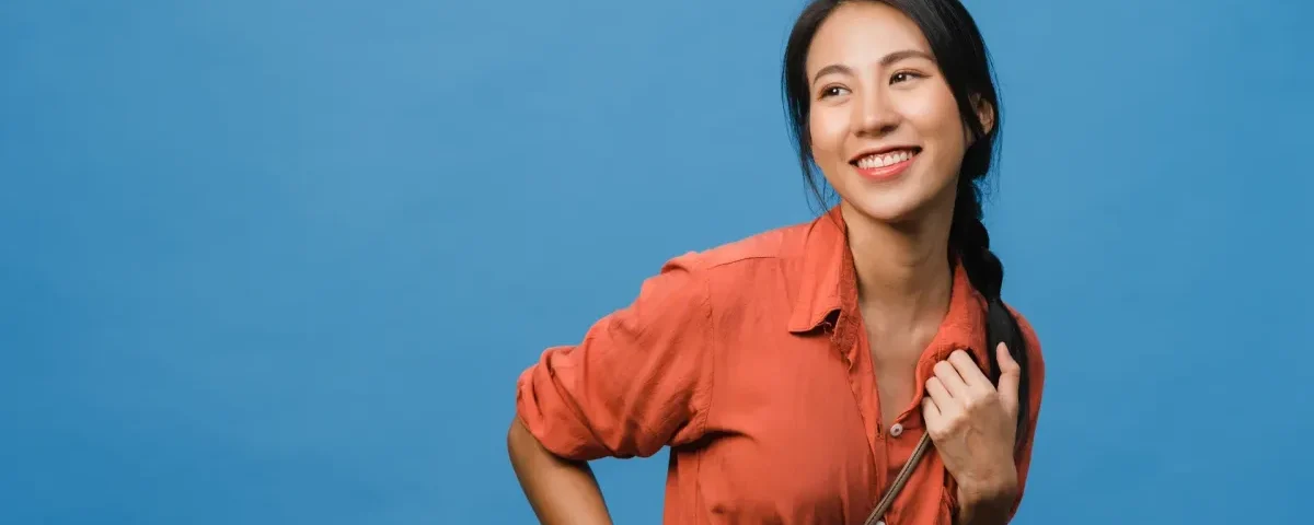 Woman smiling confidently in warm indoor setting