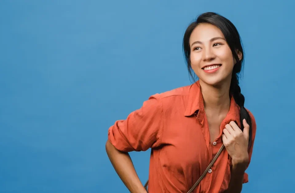 Woman smiling confidently in warm indoor setting
