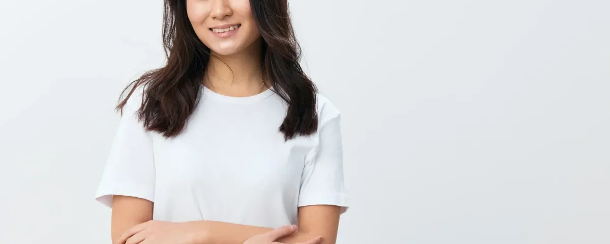 Woman smiling confidently in modern office, representing clarity and intentional commitment in relationships
