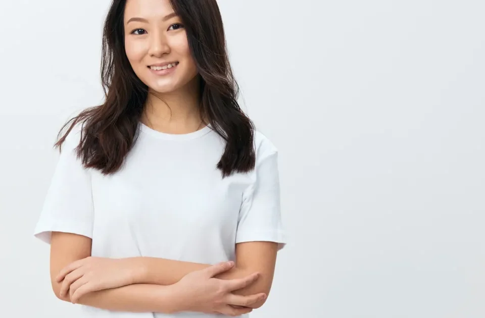 Woman smiling confidently in modern office, representing clarity and intentional commitment in relationships