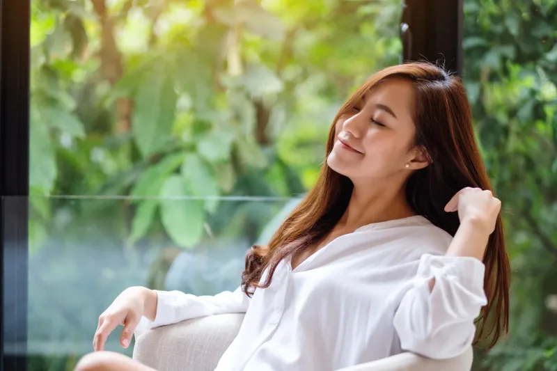 Woman seated in relaxed outdoor setting, symbolizing the family connection that confirms official relationship status in Filipino culture