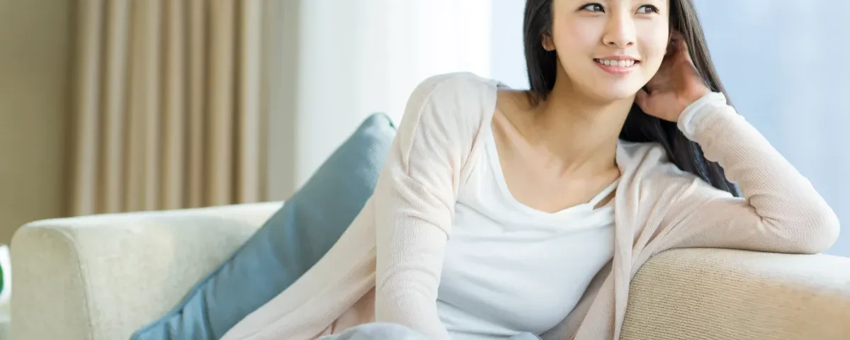 Confident young Filipina woman in casual gray shirt smiling warmly, embodying the approachable cultural values central to family introduction traditions.