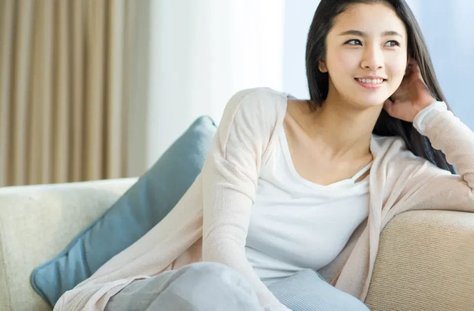 Confident young Filipina woman in casual gray shirt smiling warmly, embodying the approachable cultural values central to family introduction traditions.