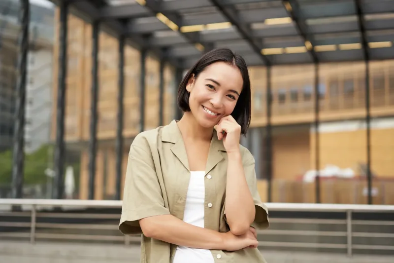 Young woman with warm smile in urban casual setting, representing the openness and genuine commitment Filipinas express through family introductions.