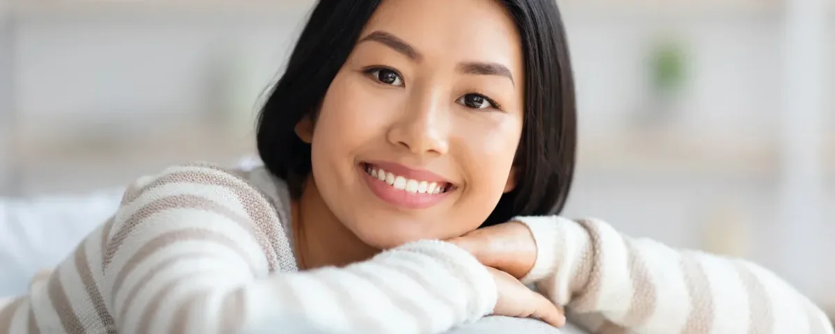 Woman smiling confidently, representing approachable and respectful first meeting expectations