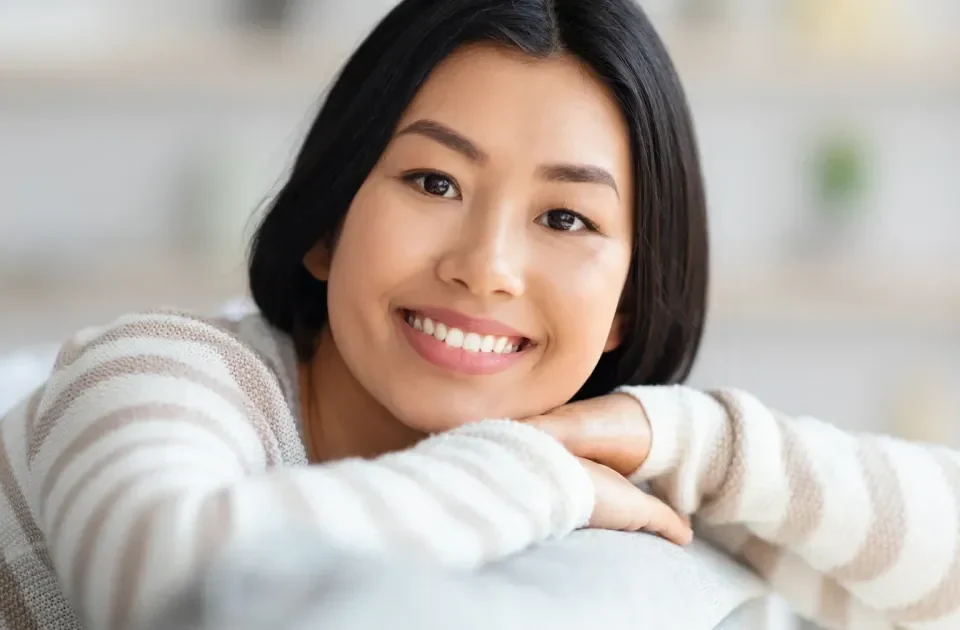 Woman smiling confidently, representing approachable and respectful first meeting expectations