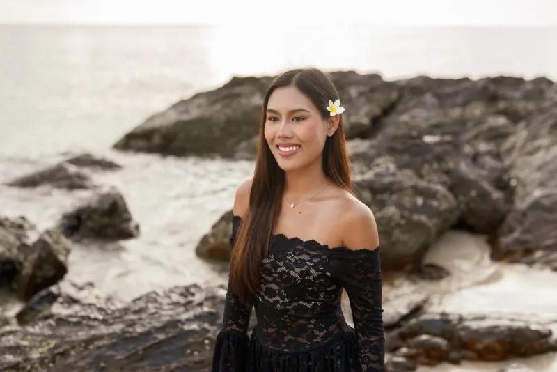 Woman smiling at beach during daytime, exemplifying relaxed Philippines travel atmosphere