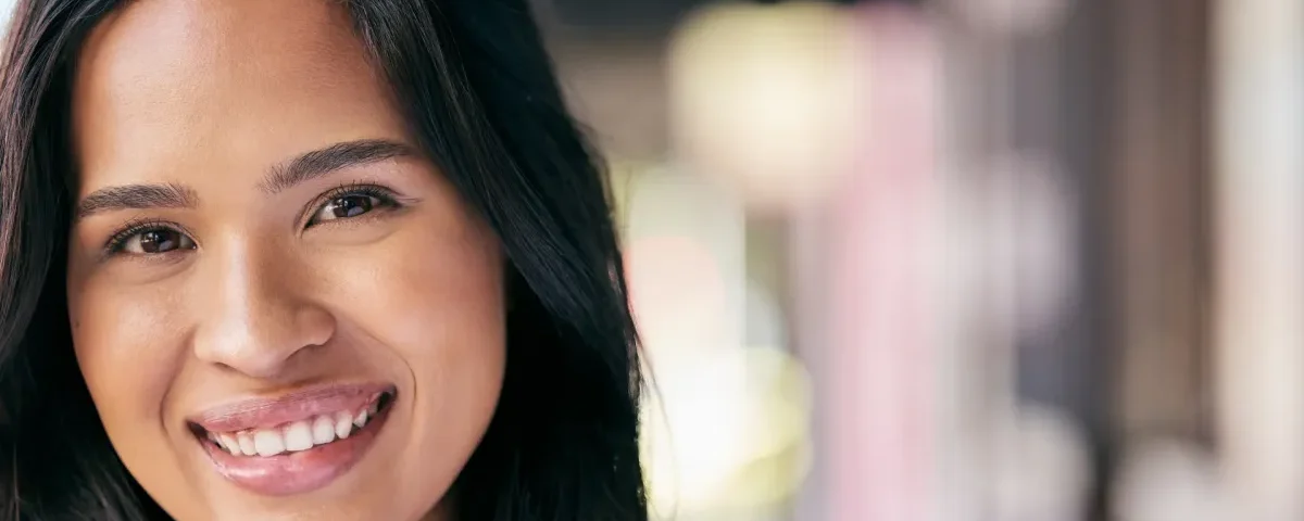 Woman with genuine smile and natural light, embodying warmth and care