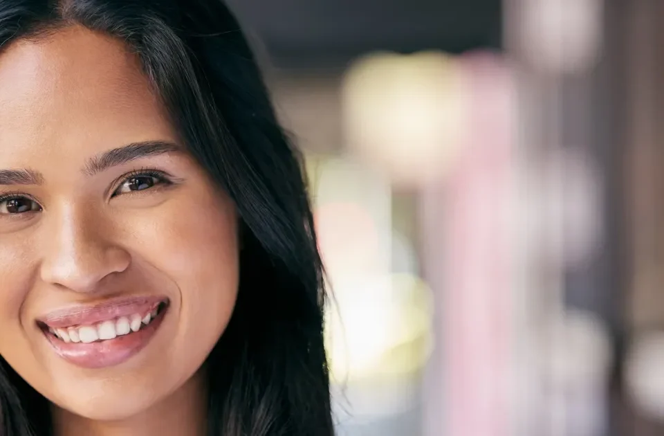 Woman with genuine smile and natural light, embodying warmth and care
